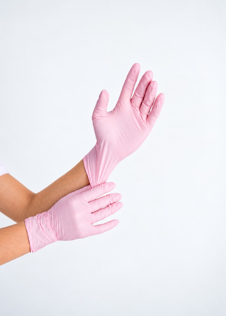 Gloved hands preparing a facial treatment
