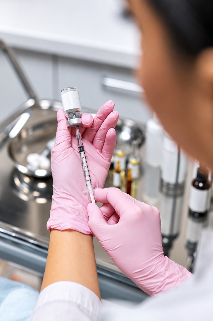 Syringe and vials arranged on a treatment tray