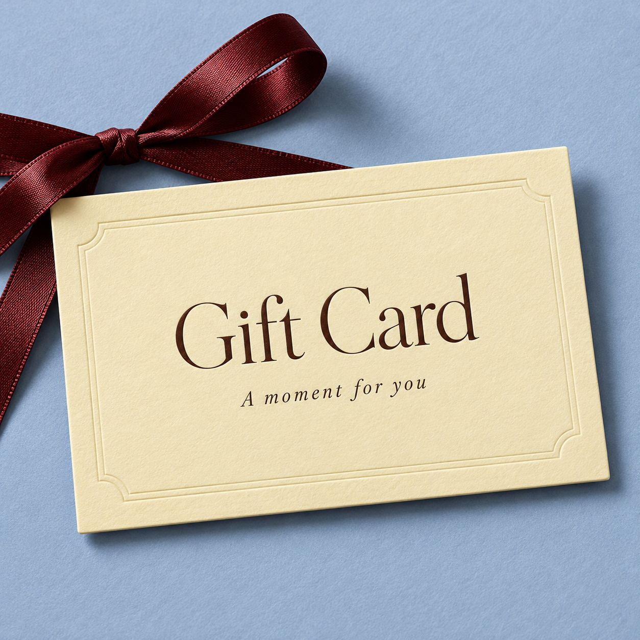 Cream gift card with a ribbon, reading Gift Card, A moment for you